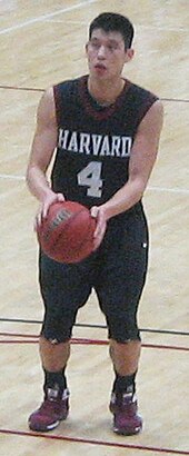 Lin wearing a crimson colored Harvard basketball jersey