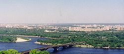 View of the left-bank Kyiv and the Dnipro River. Background high-rise buildings in the right are in the Dniprovskyi Raion.