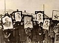 Image 8Russian peasants holding banners of Lenin (left), Marx (centre) and Trotsky (right) in early Soviet Russia. (from Russian Revolution)