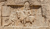 Rock relief at Naqsh-e Rustam; the Persian Sassanian emperor Shapur I (on horseback) with Roman emperors submitting to him