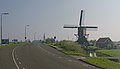 Oud Ade, windmill (de Vrouw Vennemolen) with catholic church in the background