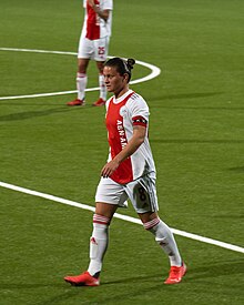 Footballer Sherida Spitse in an Ajax kit on a football pitch. Taken August 2021