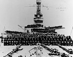 Hyperboloid mast towers were on the USS Arizona, with the ship's complement posing on her forecastle, forward turrets and superstructure, circa 1924.
