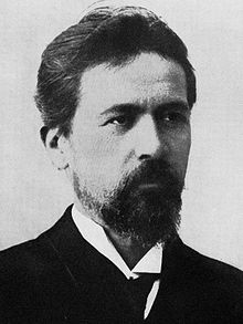 Chekhov seated at a desk