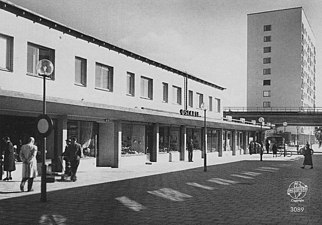 Västra torget med norra butikslängan och höghuset, 1955.