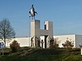 A rooster statue on a roundabout