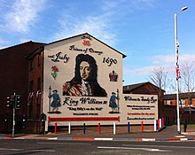 Mural on a gable wall showing William of Orange and the date of the Battle of the Boyne, with the legend "Welcome to Sandy Row".