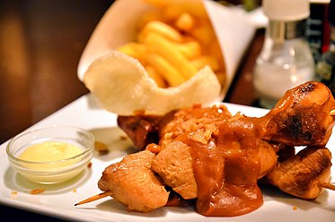 Chicken satay in the Netherlands with peanut sauce, French fries, prawn crackers, and mayonnaise; as served in a pub in Amsterdam
