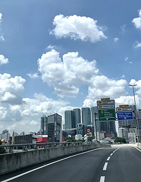 SPE heading towards its western terminus at Kerinchi interchange with the Petaling Jaya skyline in the background.jpg