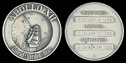 Apollo 12 mission emblem and crew names (front). Dates (launch, lunar landing, and return), and serial number 1 (back)