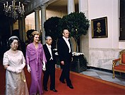 The Fords escort Japanese Emperor Hirohito and Empress Kōjun down the Cross Hall towards the East Room during an October 1975 state dinner honoring the Japanese royals.