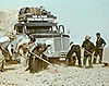 The truck carrying the ice block gets stuck in the Sahara sand