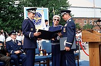 Air Force Chief of Staff Gen. Larry D. Welch presents a retirement certificate to Commander of Air Mobility Command Gen. Duane H. Cassidy at Scott Air Force Base in Belleville, Illinois on September 22, 1989.