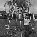 Boy in front of jungle gym, 1967