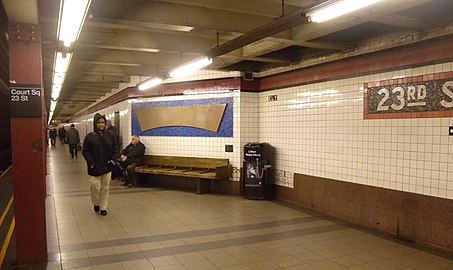 The Manhattan-bound platform with updated Helvetica signs and a part of Temple Quad Reliefs
