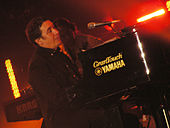 Jools Holland playing a piano on stage