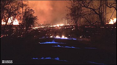 Blue flames from burning methane gas in Leilani Estates, on 22 May 2018, 11:30 p.m. HST.[41]