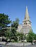 The east part of a stone church having a tower with a broach spire