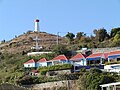 Gustavia Lighthouse and canons on hill above Gustavia Harbor