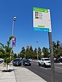 Bus stop sign at a stop featuring a bus bulb curb