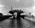USS Makin Island (CVE-93) halfway into USS ABSD-6, at Guam, 8 June 1945