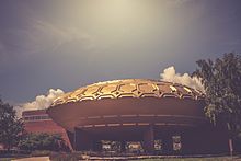 The Golden Rondelle Theater, a round structure with a golden roof. The theater was built for the 1964 New York World's Fair and then relocated to the Johnson Wax Headquarters.