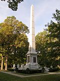 White monumental obelisk in the trees