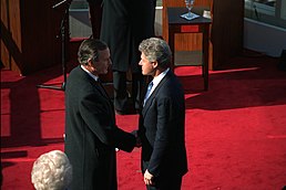 Photograph of George Bush and Bill Clinton shaking hands just after the inaugural ceremonies at the U.S. Capitol.