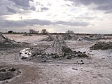 Mud volcanoes close to the Salton Buttes. Center, a gryphon; left foreground, part of a salse