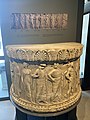 Semicircular marble base, likely a decorative aspect of the altar of Apollo at the Monument of Augustus. Depicted are various gods and heroes of the Greek Pantheon, note the archaistic style.