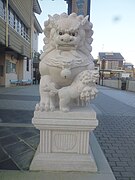 Detail view of left Komainu outside the gate of Saikouji in Toyohashi with cub