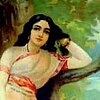 A young woman in a white sari leaning on a tree