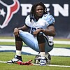 Chris Johnson sitting on his guard helmet at an American football game in 2010