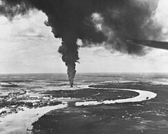 Saigon afire after aerial attacks from carrier-based planes of the US Pacific Fleet in 1945.