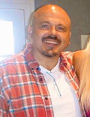 Walter Afanasieff smiling in a red plaid shirt