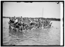 Swimmers and an announcer participating in an event at the Tidal Basin Bathing Beach, with the Washington Monument in the background. (August 1924)