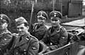 SD men in Poland 1939. The SD men are wearing army shoulder straps, akin to the Waffen-SS,[111] except for the Rottenführer in the front seat, who is wearing the older shoulder straps of the Allgemeine SS.
