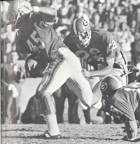 Carlos Alvarez running with the ball, guarded by another Gator