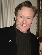 A medium shot of Conan O'Brien smiling at the camera