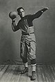 Fritz Pollard, posing with a football