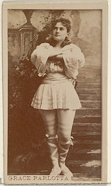 Woman in short dress standing with arms crossed