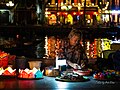 An old lady is selling water lanterns in Hội An