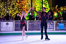 Yehor Yehorov ice skating with his partner Molly Cesanek in Cleveland Public Square at Christmas time