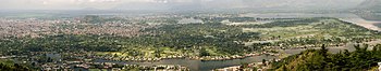 Panorama of city in green area near a river and lakes