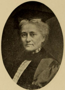 An older white woman in academic cap and gown, in an oval frame