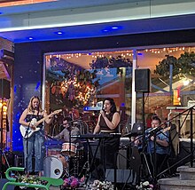 Dorothea Paas performing with band outside of a cafe.