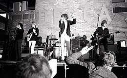 black and white photograph of the band on stage in 1965