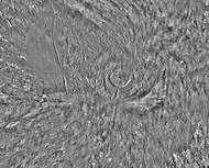 Arsia Mons and its surroundings in a THEMIS daytime infrared image mosaic. A huge fan-shaped expanse of knobby deposits (the Arsia Sulci), believed left by past glaciation, extends northwestward from the mountain.