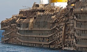 Starboard side of the righted Costa Concordia, showing the crushing impact of the rock spurs upon which it rested.
