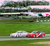 Matt Neal (Mazda Xedos) disputing a position with Geoff Steel (BMW 318is) at Brands Hatch during the 1994 BTCC Championship.
